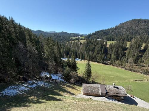 an old barn in the middle of a grassy field at Chalet Schipplbadstube by Interhome in Annaberg im Lammertal