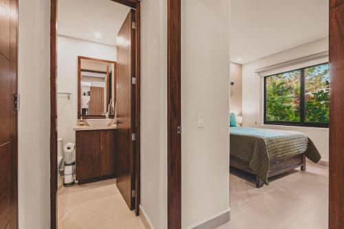 a bedroom with a bed and a bathroom with a mirror at Casa de Luz Beachfront Oasis w Ocean Views Pool in San Francisco