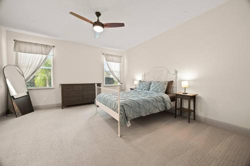 a bedroom with a bed and a ceiling fan at The Fiddyment Roost in Roseville