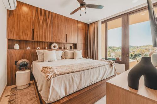a bedroom with a bed and a large window at Your Sayulita Getaway in Sayulita