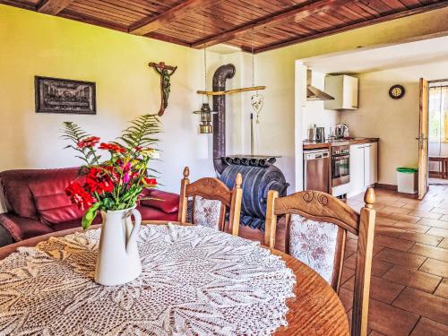 a dining room with a table with a vase of flowers at Holiday Home Fish & Boat by Interhome in Hurka