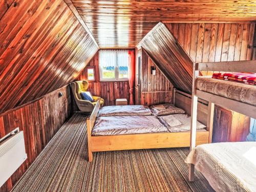 a bedroom with a bunk bed in a wooden cabin at Holiday Home Fish & Boat by Interhome in Hurka