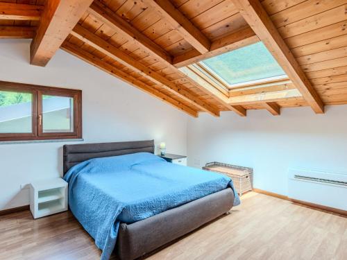 a bedroom with a bed and a wooden ceiling at Apartment Borgo Castello-4 by Interhome in Argegno