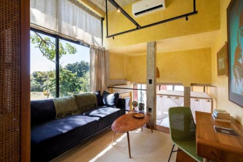 a living room with a couch and a table at Sumba Lodge in Manuel Antonio