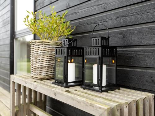 two black candles on a table with a basket at Holiday Home Sigrun - 300m from the sea by Interhome in Kelstrup Strand