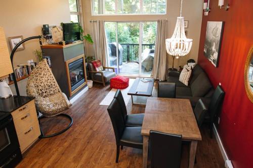 a living room with a couch and a table at The Inlet Haven - 2 Bedroom on the Inlet in Ucluelet