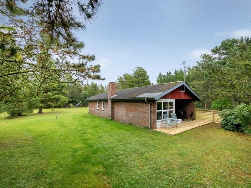 a small brick house with a large yard at Holiday Home Åsemarie - 500m to the fjord by Interhome in Halby