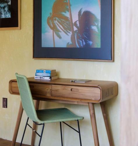 a desk with a chair and a picture on the wall at Sumba Lodge in Manuel Antonio