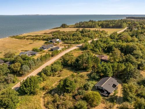 an aerial view of a house on a farm next to the water at Holiday Home Marisol - 250m to the fjord by Interhome in Furland