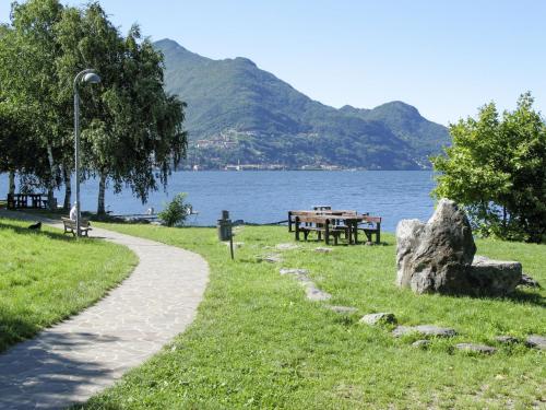 a path in a park next to a body of water at Apartment Casa di Edi by Interhome in Dervio