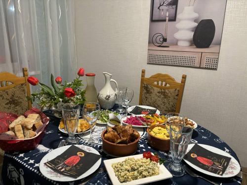 a table with a blue table cloth with food on it at Vashlovani Sweet Home in Dedoplis Tskaro