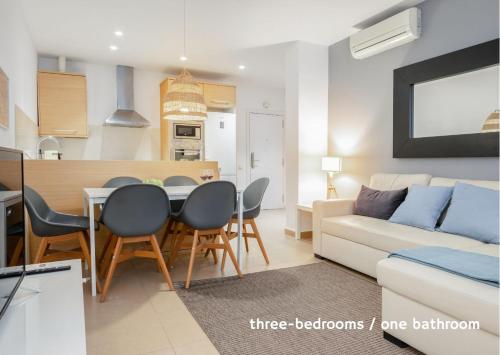 a kitchen and a living room with a table and chairs at Inside Barcelona Apartments Salva in Barcelona