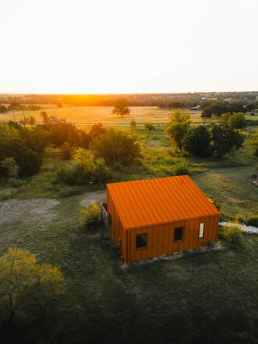 an orange cabin with an orange roof in a field at The Martinsburg in Stonewall