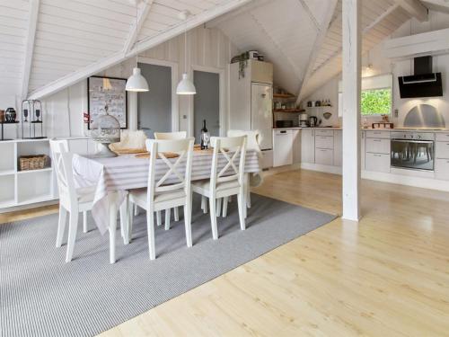 a kitchen and dining room with a table and chairs at Holiday Home Helke - 30km from the sea by Interhome in Arrild