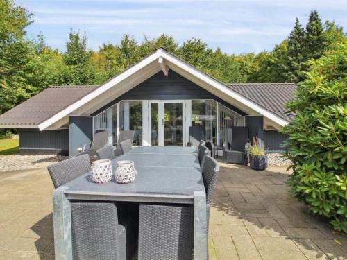 a dining table and chairs on a patio at Holiday Home Helke - 30km from the sea by Interhome in Arrild