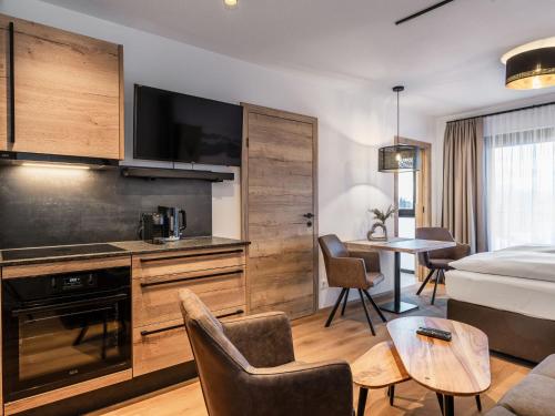 a hotel room with a kitchen and a living room at Studio Studio Taxacher by Interhome in Krinberg