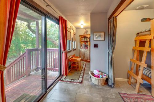 a room with a balcony with a sliding glass door at Peaceful Helotes Cabin Fire Pit, 9 Mi to Old Town in Helotes