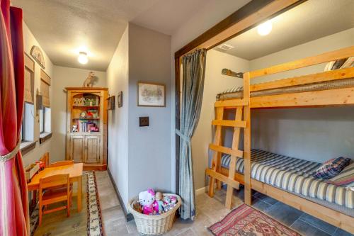 a bedroom with two bunk beds and a desk at Peaceful Helotes Cabin Fire Pit, 9 Mi to Old Town in Helotes