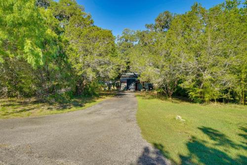 an empty road in a park with trees at Peaceful Helotes Cabin Fire Pit, 9 Mi to Old Town in Helotes