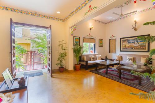 a living room with a couch and a table at Vasant Vilas in Udaipur