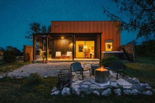a home with a fire pit in the yard at night at The Martinsburg in Stonewall