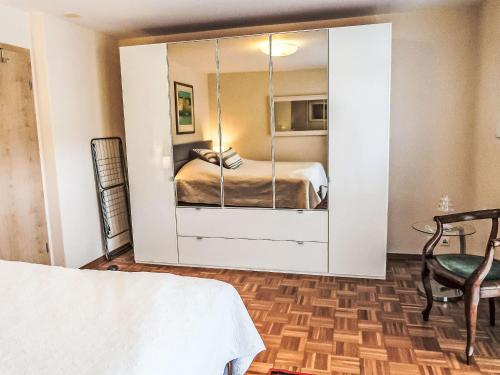 a bedroom with a bed and a mirror at Apartment Residenz Marina-63 by Interhome in Bouveret