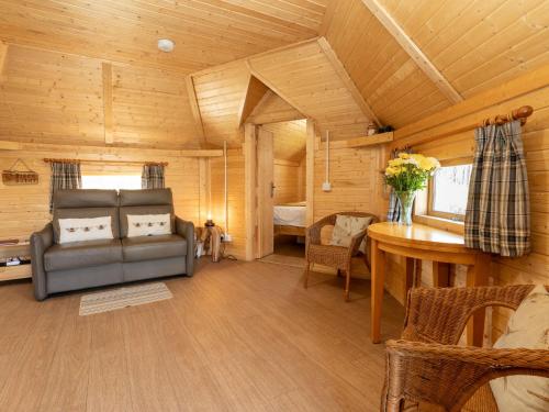 a living room with a couch and a bedroom at Apartment Birch Bothy by Interhome in Coldstone