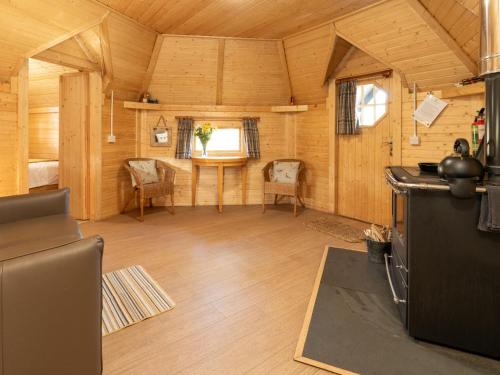 a large room with a table and chairs in a cabin at Apartment Birch Bothy by Interhome in Coldstone