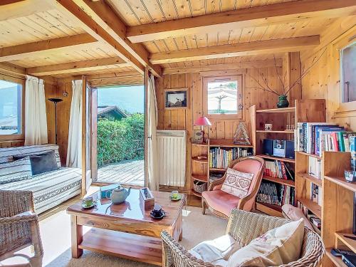 a living room with a table and chairs in a room at Holiday Home Les Chalets de La Combe by Interhome in Mémontel