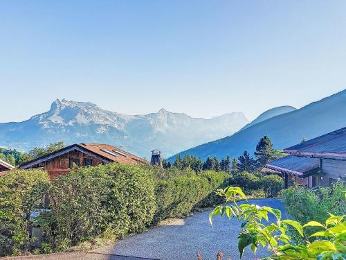 a river with houses and mountains in the background at Holiday Home Les Chalets de La Combe by Interhome in Mémontel