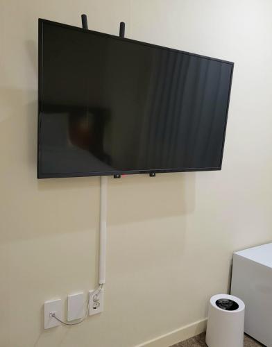 a flat screen tv hanging on a wall at jeonju hotel book and type in Jeonju