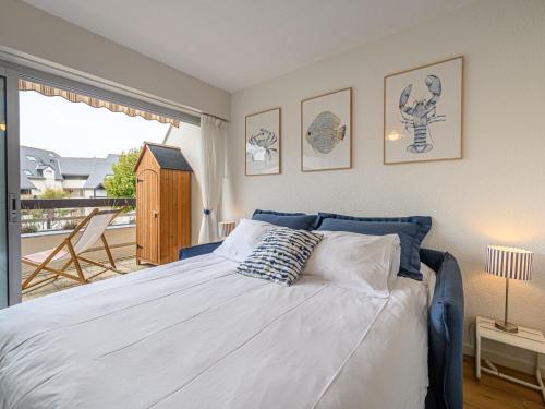 a bedroom with a large bed and a balcony at Apartment Maison Port En Dro-12 by Interhome in Légenès