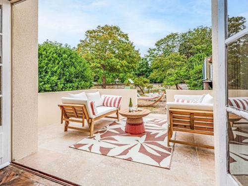 a patio with two chairs and a table at Holiday Home Maison Amour by Interhome in Dives-sur-Mer