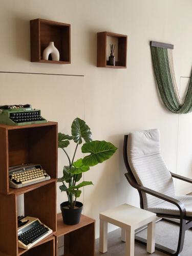 a room with a chair and a desk and a plant at jeonju hotel book and type in Jeonju