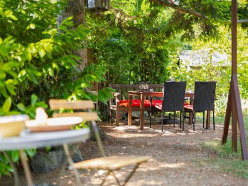 a table and chairs sitting under a tree with a table and chairs at Holiday Home Clarissa by Interhome in Balatonakali