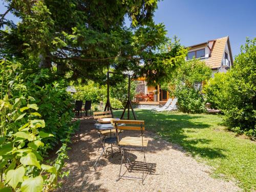a yard with two chairs and a swing at Holiday Home Clarissa by Interhome in Balatonakali