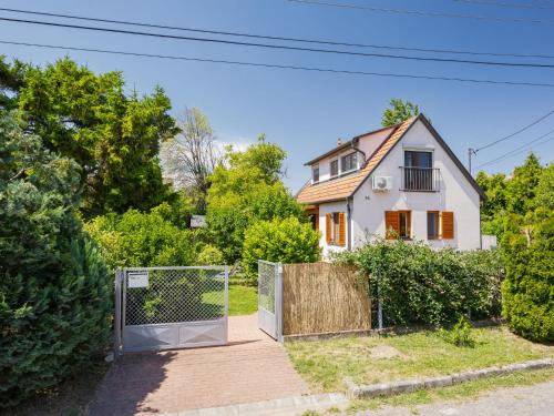 a house with a gate in front of a house at Holiday Home Clarissa by Interhome in Balatonakali