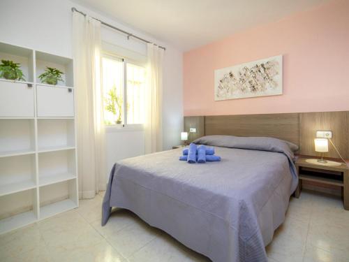 a bedroom with a bed with blue towels on it at Apartment Imperial Park-23 by Interhome in Casas de Torrat