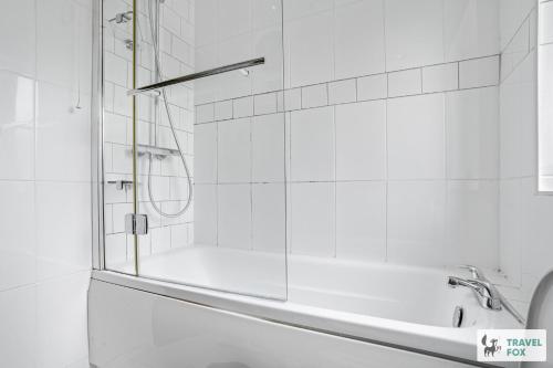 a white bathroom with a shower and a tub at Emma's Central House & Parking in Nottingham