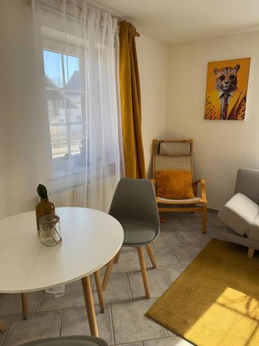 a living room with a table and a chair at Ferienwohnung Malia in Neubulach