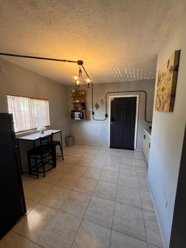 a kitchen and dining room with a table and a ceiling at Estancias Nava #1 in San Antonio