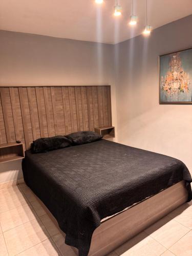 a bedroom with a large bed in a room at Estancias Nava #1 in San Antonio