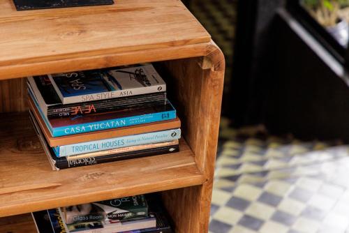 a stack of books sitting on a wooden table at Sumba Lodge in Manuel Antonio