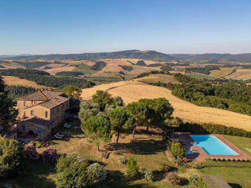 an aerial view of a house and a swimming pool in a field at Apartment Torrenieri by Interhome in Vergelle