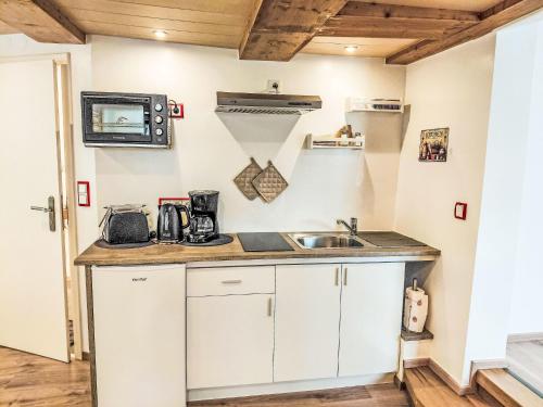 a kitchen with white cabinets and a sink at Apartment Marie by Interhome in Schieder-Schwalenberg