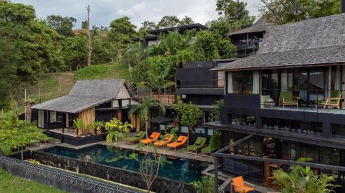 an aerial view of a house with a swimming pool at Sumba Lodge in Manuel Antonio