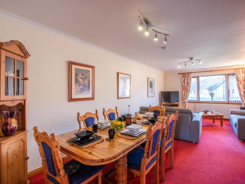 a dining room with a wooden table and chairs at Holiday Home Coiltie House by Interhome in Drumnadrochit