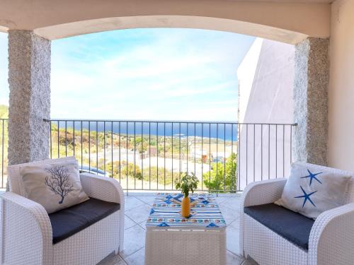 a balcony with two chairs and a table with a view at Apartment Vista Paradiso by Interhome in Cascabraga