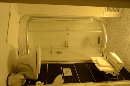a bathroom with a tub and a toilet and a sink at Sinop Dolunay Hotel in Sinop