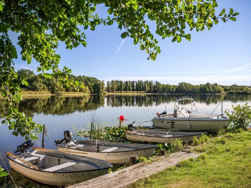 three boats are docked on a lake at Holiday Home Stenlycke by Interhome in Ivö